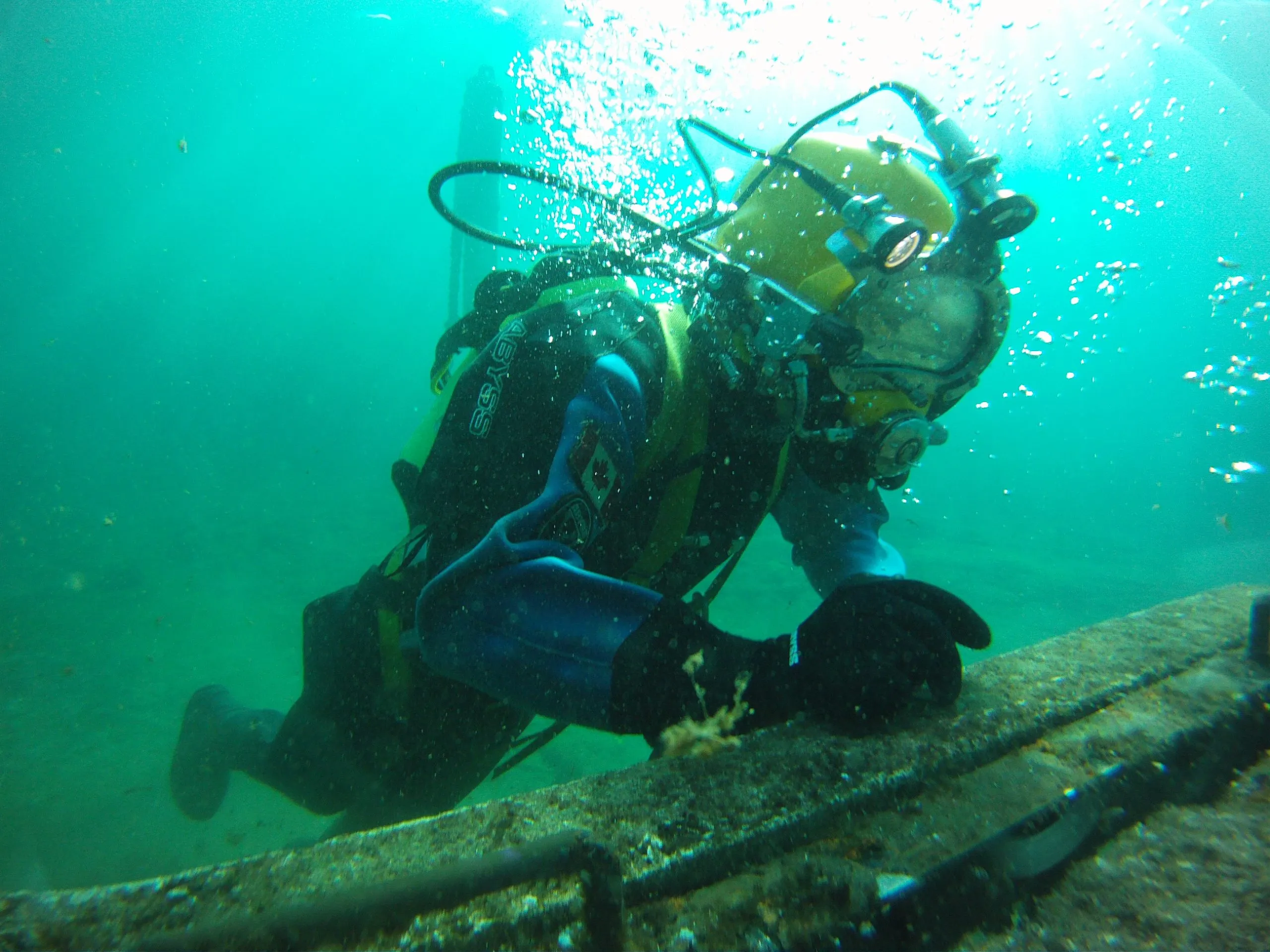Commercial diver in surface supplied diving equipment during an operational dive